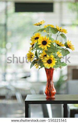 Sunflowers In A Vase Of Red