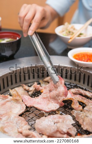 girl are clamping pork when eating BBQ , food