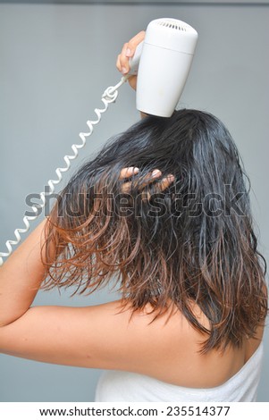 woman is blowing her hair with hair dryer, Electric hair dryer