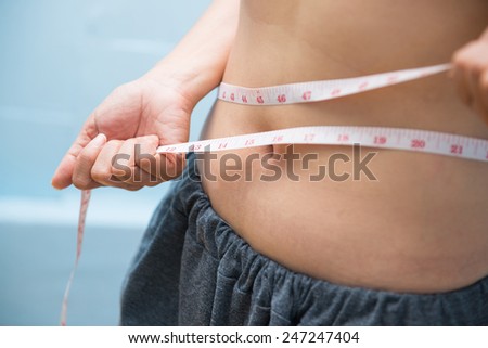 Fat girl holding a measuring tape, healthy