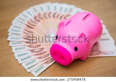 Thai money banknotes with Piggy piggy bank, saving