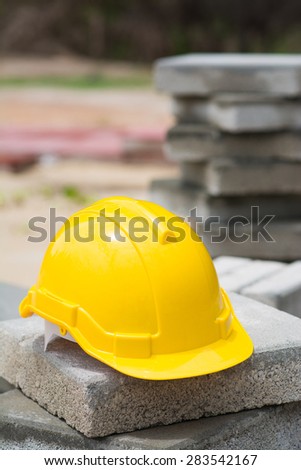 yellow hard hat on brick blocks, construction