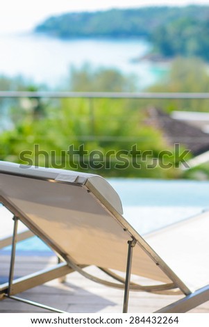 white beach chairs by the pool, villa