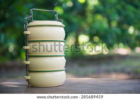 Yellow metal carrier food placed on a wooden, box