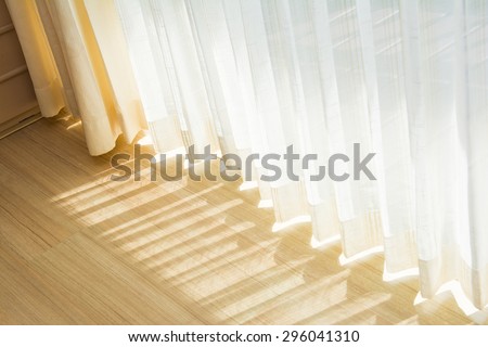 Shadow from shining through a door and the curtains, white room