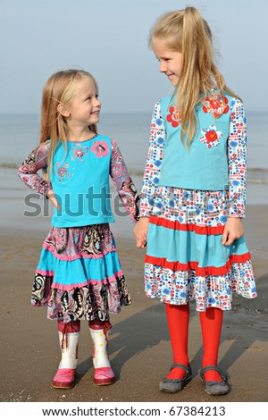Two cute little girls holding hands
