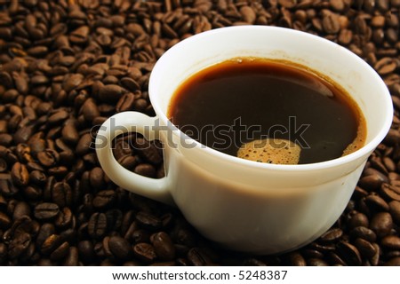 Cap of coffee on coffee bean background
