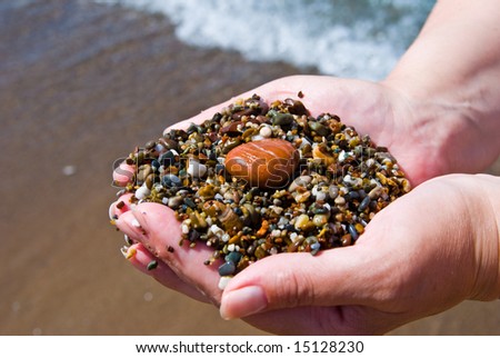 Hands with the sea sand