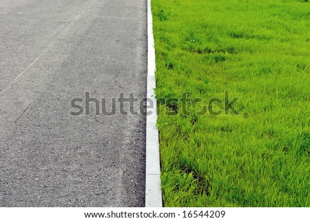 road and green grass field background. Ecological concept