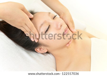 Pretty woman receiving facial massage