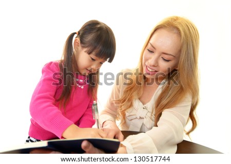 Little girl studying in English with teacher