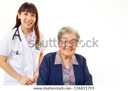 Smiling doctor with elderly woman