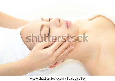 Pretty woman receiving facial massage