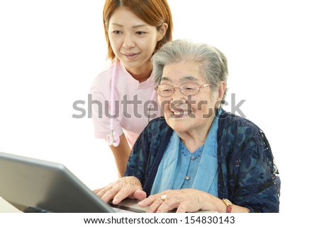 Old woman enjoys computer