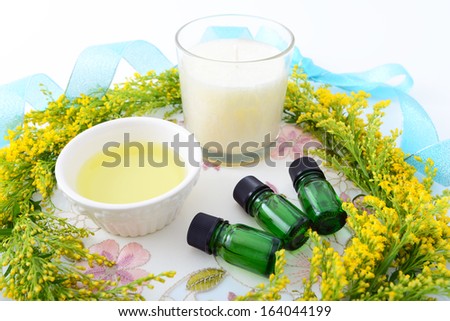 Bottles of essential oils with floral garland