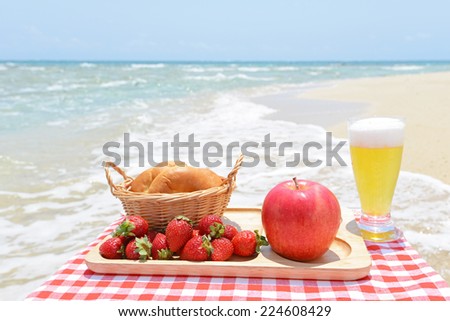 Fresh fruits with beer on the sandy beach