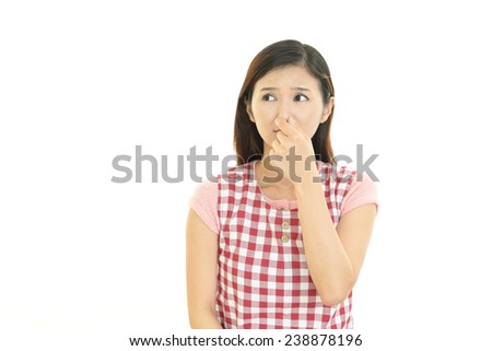 Woman holding her nose against a bad smell