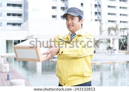 Asian courier delivering a package