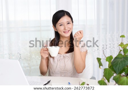 Smiling Asian woman with laptop