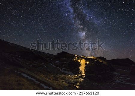 Amazing starry night in the high mountains with falling stars