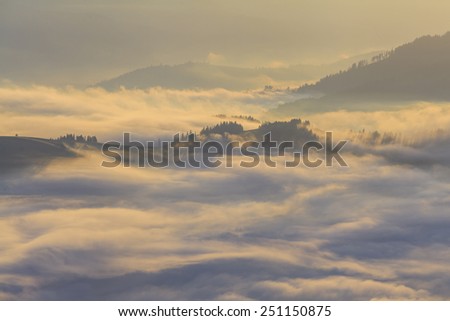 Amazing mountain landscape with dense fog. Carpathian Mountains.