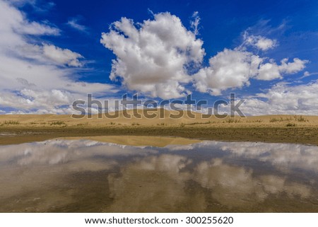 Gobi Desert after rain. Reflection of clouds in pools.