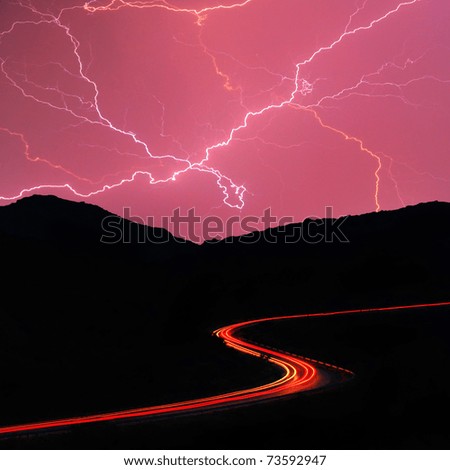 Night road in the mountains during a thunderstorm