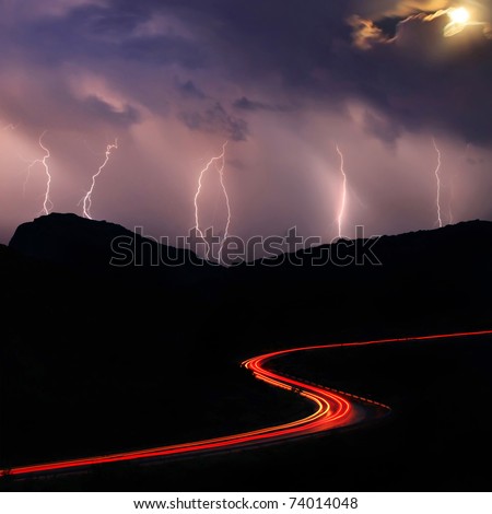 Night road in the mountains during a thunderstorm