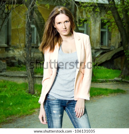 Fashion portrait of beautiful woman posing on old school background