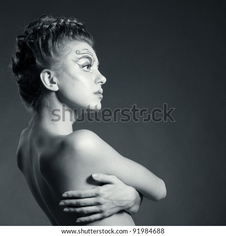 Black and white fashion portrait of beautiful woman posing on black background