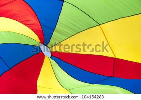 A colorful fabric with red, yellow, blue and green  stripes for background use