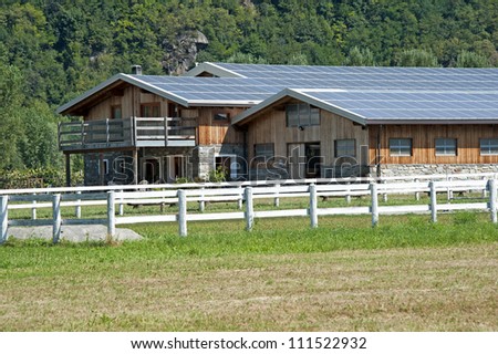 A modern farm with solar panels on the roof