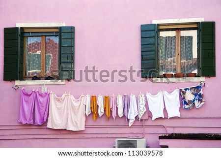 Laundry hanging out of a typical house of Burano Island - Venice,  Italy