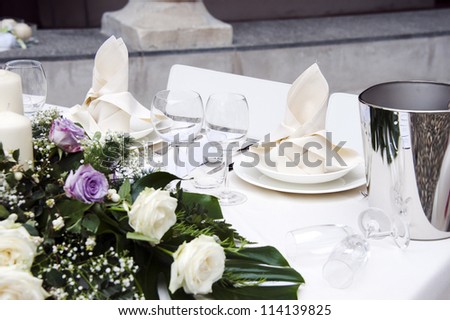 Romantic table setting for two with a bouquet of roses