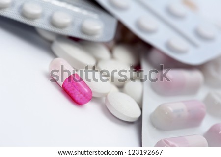 Pills and pills blisters on white background