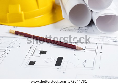 Architecture tools with blueprints, safety hat and pencil