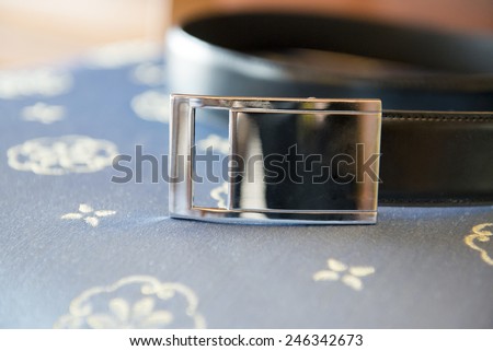 A black man belt with silver buckle