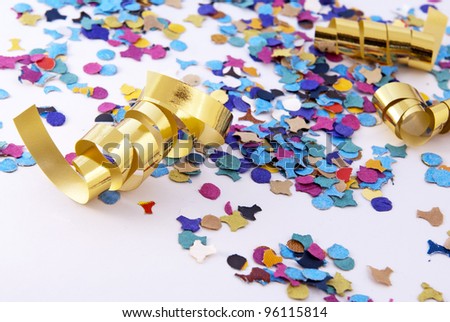 Colorful confetti and party streamer over white background