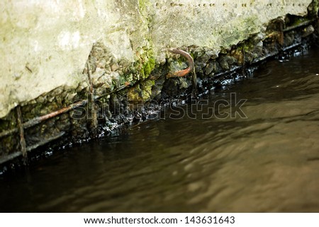 Old concrete wall under the influence of water