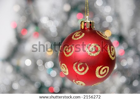 Red christmas ball against cold background