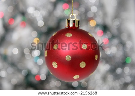 Red christmas ball against cold background