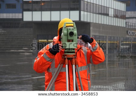 Surveyor measuring land for construction with theodolite