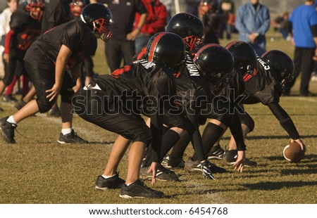 youth playing american football - advancing with new play