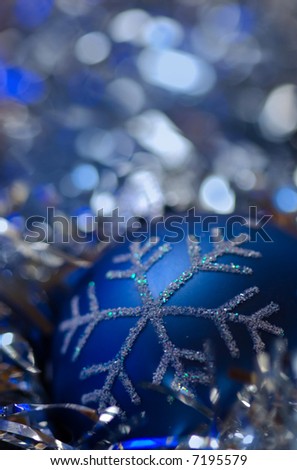 Blue christmas ornament against blue, cold background