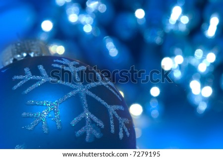Christmas ornament against sparkling blue background
