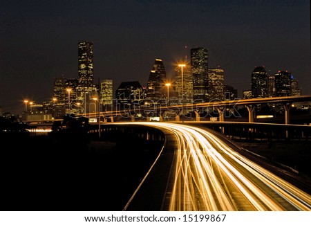 Traffic on highway exiting the city of Houston at night