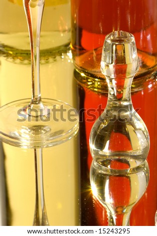 Glass stopper lid of a carafe with red and white bottle of wine in background