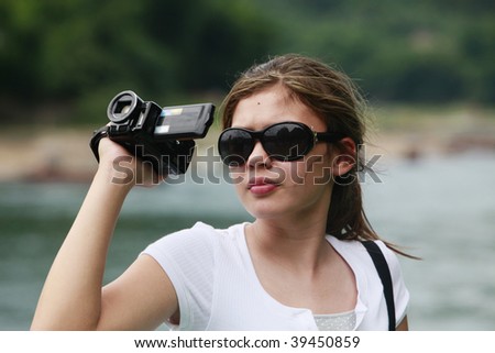 Tourist filming scenic landscape with digital camera