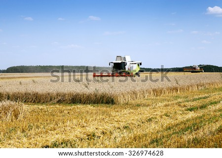 Agricultural field on which works Harvester, harvested cereals