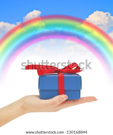 gift in hand rainbow blue summer sky
